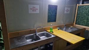 a bathroom with two sinks and a wooden counter at Camping Principata in Brungaj