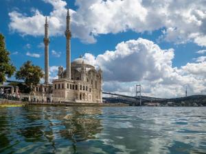 a building with two towers on a body of water at Nevv City Hotel in Istanbul