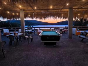 a pool table in a restaurant with a view of the ocean at Camping Principata in Brungaj