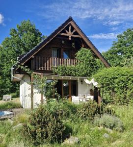 ein kleines Haus mit einem Mansarddach in der Unterkunft Czapliniec in Laski