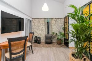 a living room with a table and a stove at La Fuente 33 in Castro-Urdiales