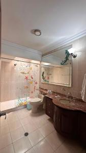a bathroom with a toilet and a sink and a shower at Hotel Casa Sharon in Cali +39 photos