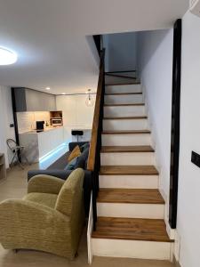 a staircase leading up to a living room and kitchen at Serena Boutique Duplex in Madrid