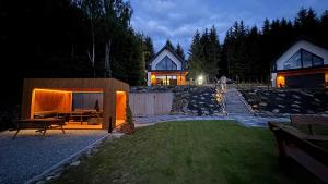 a backyard of a house with a fire place at Domki na Stronie C in Stronie Śląskie