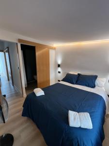 a bedroom with a large blue bed with two pillows at Serena Boutique Duplex in Madrid