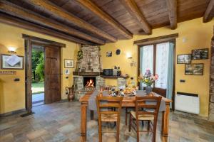 a dining room with a table and a fireplace at Casa Buonumore in Gaiola