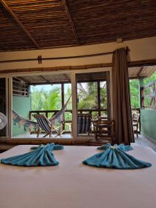 a bedroom with a bed with a hammock and a view at El Marabu Chill'n Surf in Aposentillo +137 photos