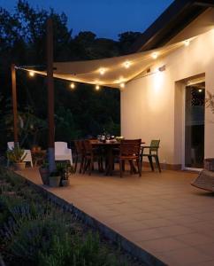 a patio with a table and chairs and lights at Terrazza Ganzaria in San Michele di Ganzaria