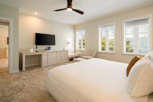 a bedroom with a bed and a flat screen tv at Cardozo Hotel in Miami Beach
