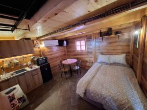 a bedroom with a bed in a wooden room at Brvnara Mia in Rudnik