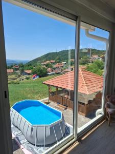 a view of a swimming pool from a window at Brvnara Mia in Rudnik