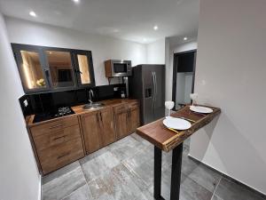 a kitchen with a wooden table and a sink at Bed and breakfast ALDIANA in Cap Skirring