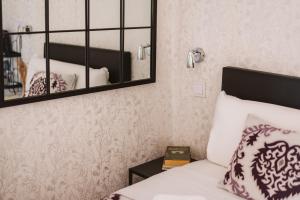 a bedroom with a bed and a mirror at Charme da Graça - Guest House in Lisbon