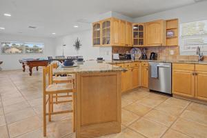 a large kitchen with wooden cabinets and a table at Manatee Bay in Apollo Beach