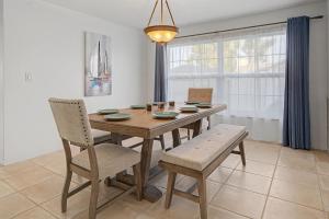 a dining room with a wooden table and chairs at Manatee Bay in Apollo Beach
