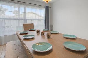 a wooden table with blue and green plates on it at Manatee Bay in Apollo Beach