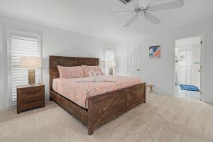 a bedroom with a bed and a ceiling fan at Manatee Bay in Apollo Beach +43 photos