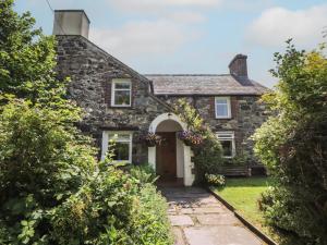 an old stone house with a front door at Plas Mawr in Caernarfon