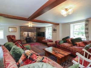 a living room with couches and a fireplace at Plas Mawr in Caernarfon