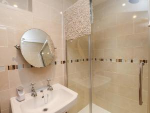 a bathroom with a shower and a sink and a mirror at Plas Mawr in Caernarfon +21 photos