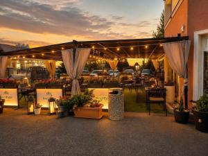a patio with a bunch of plants and flowers at Hotel Evan u Hoffera with free parking in Topoľčany