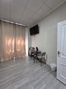 a room with chairs and a table and a tv at Hotel La Oficina in San Miguel de Salinas +12 photos