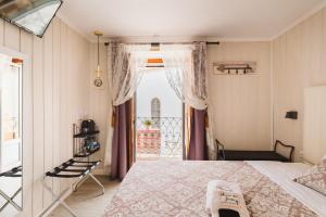 a bedroom with a bed and a balcony at Charme da Graça - Guest House in Lisbon
