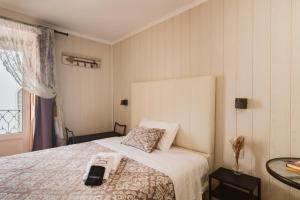 a room with a bed with a phone on it at Charme da Graça - Guest House in Lisbon