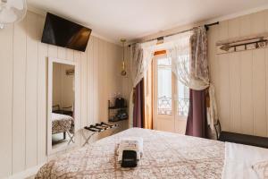 a bedroom with a bed and a window at Charme da Graça - Guest House in Lisbon