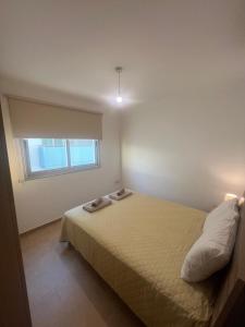 a bedroom with a bed and a window at Melissa 2 Block A in Paralimni