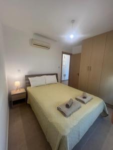 a bedroom with a bed with two towels on it at Melissa 2 Block A in Paralimni