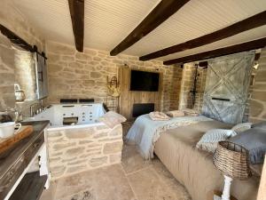 a bedroom with a bed and a sink and a tub at Le Petit Refuge - La Petite Longère in Rahon