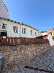 a stone fence in front of a house at RAST apartment house in Třebíč