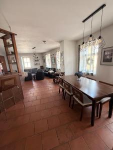a dining room and living room with a wooden table at RAST apartment house in Třebíč