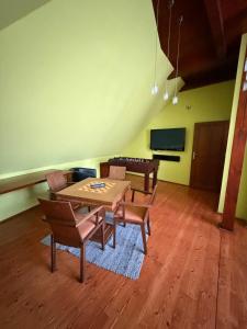 a dining room with a wooden table and chairs at RAST apartment house in Třebíč