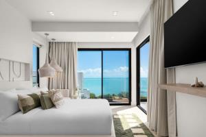a bedroom with a large white bed and a large window at Villa Angelina in Leeward +29 photos