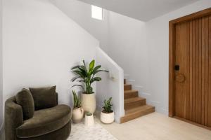 a living room with a chair and potted plants at Villa Angelina in Leeward