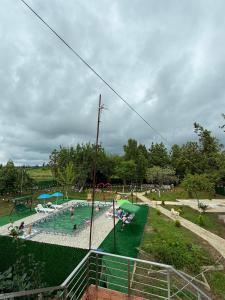 a large swimming pool with people in a park at ტყუპები in Kobuleti