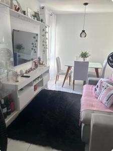 a living room with a couch and a table at Apto no Janga in Paulista
