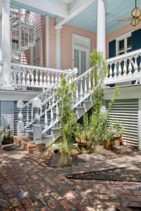 a house with a white railing and a staircase at The Ashley Speakeasy King Suite includes breakfast in Charleston