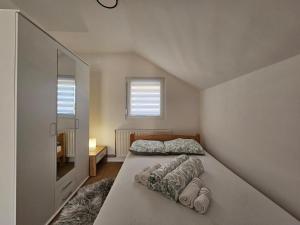 a bedroom with a bed and a television in it at Airport Apartment II in Surčin