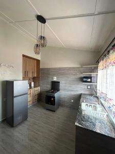a kitchen with a refrigerator and a stove in it at Aviela Residences in Solwezi