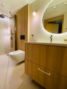 a bathroom with a sink and a toilet and a mirror at Orla Przystań in Gliczarów Górny +18 photos