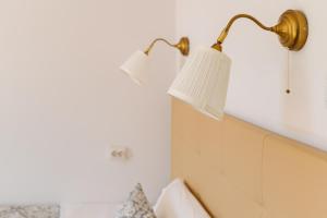a lamp hanging on a wall next to a bed at Charme da Graça - Guest House in Lisbon +28 photos
