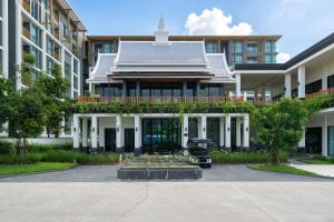 a building with a garden in front of it at Ozon condo Family apartment in Phuket