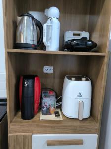 a cupboard filled with lots of kitchen appliances at Loft Misiones 226 in Puerto Iguazú +2 photos