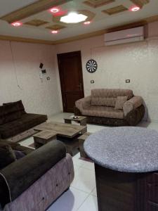 a living room with couches and a table at شقة 24 in Irbid