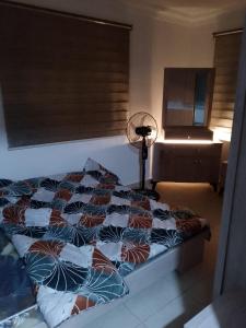 a bedroom with a bed and a fan at شقة 24 in Irbid