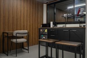 a kitchen with a counter and two stools and a sink at Cocles Green Studios in Cocles