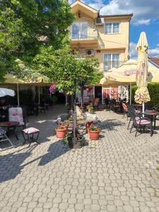 a patio with tables and chairs and a building at Apartment Emir in Mostar